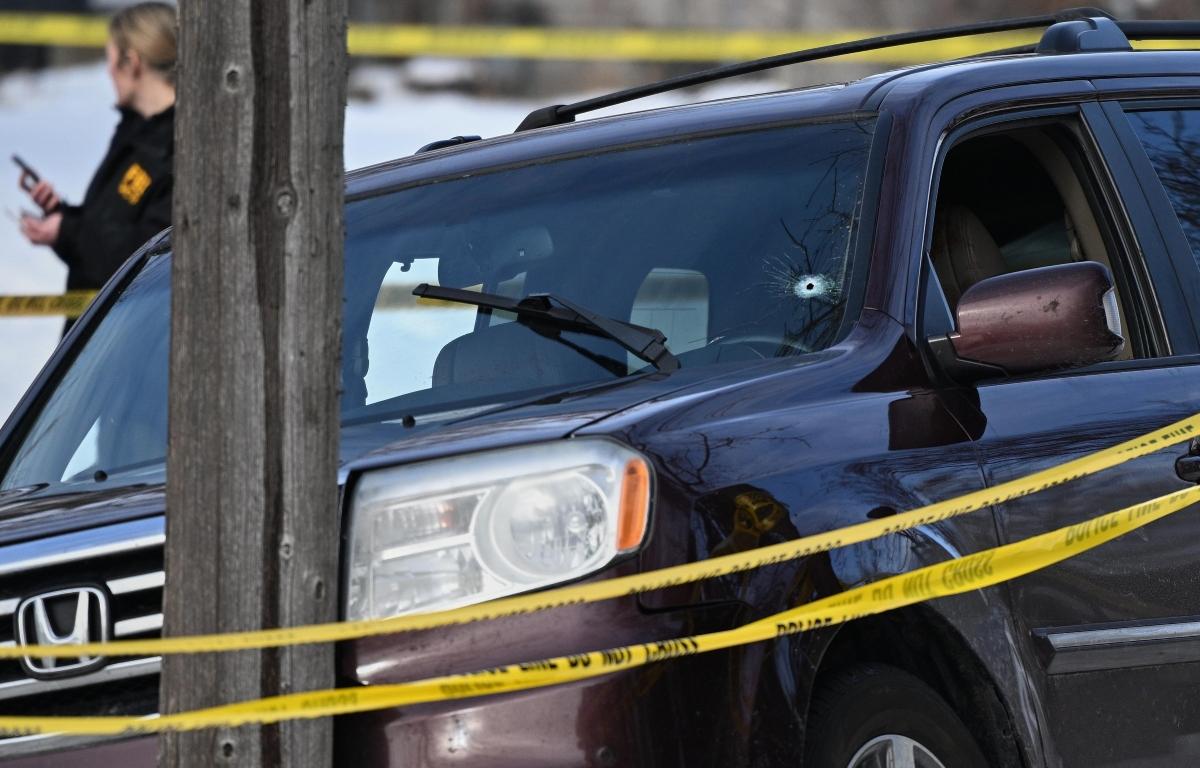 A bullet hole is seen in the windshield as law enforcement officers work at the scene of a shooting involving federal law enforcement agents, Wednesday, Jan. 7, 2026, in Minneapolis. (AP Photo/Tom Baker)