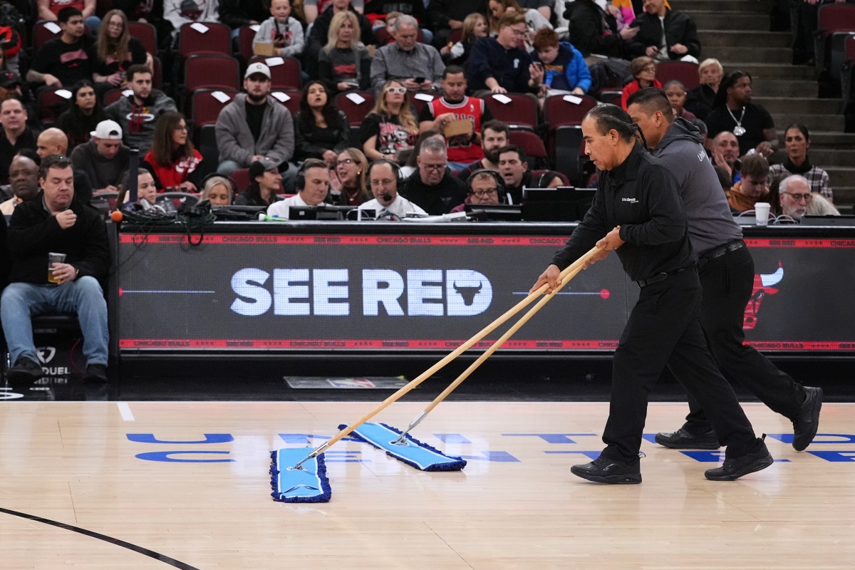 United Center employees clean the court during a delay before an NBA basketball game against the Miami Heat in Chicago, Thursday, Jan. 8, 2026. (AP Photo/Nam Y. Huh)
