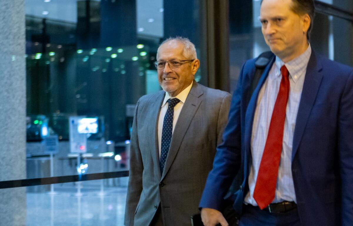 Fidel Marquez, a former Commonwealth Edison executive-turned-cooperating witness, leaves the Dirksen Federal Courthouse with his attorney on Tuesday, Nov. 12, 2024, after his fifth day of testimony in the bribery and racketeering trial of former Illinois House Speaker Michael Madigan. (Capitol News Illinois photo by Andrew Adams)