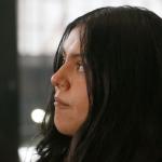 Marimar Martinez looks at her attorney with tears in her eyes as he speaks to press about the lingering impact the shooting has had on her after a Feb. 6, 2026, hearing to modify the protective order sealing evidence in her case. (Capitol News Illinois photo by Maggie Dougherty)