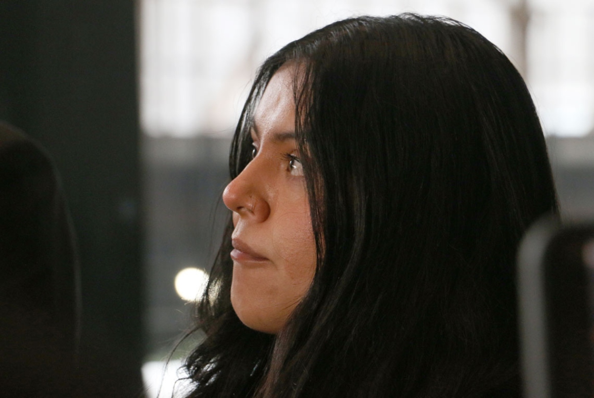 Marimar Martinez looks at her attorney with tears in her eyes as he speaks to press about the lingering impact the shooting has had on her after a Feb. 6, 2026, hearing to modify the protective order sealing evidence in her case. (Capitol News Illinois photo by Maggie Dougherty)