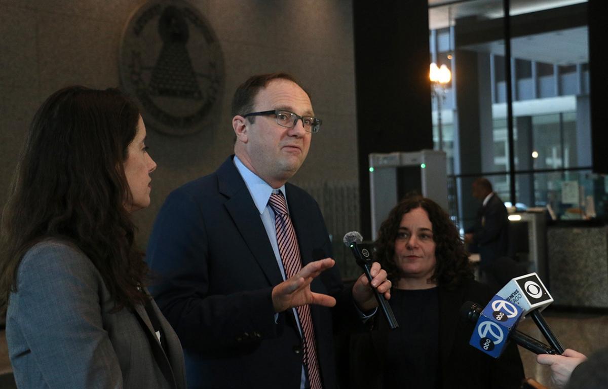 National Immigrant Justice Center attorneys Mark Fleming and Keren Zwick, right, and ACLU of Illinois attorney Michelle García speak to reporters at the Dirksen Federal Courthouse in downtown Chicago after a Feb. 13, 2026, hearing on warrantless immigration arrests amid Operation Midway Blitz. (Capitol News Illinois photo by Maggie Dougherty)