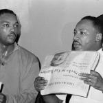 FILE - Civil rights leader Dr. Martin Luther King, Jr., right, and his aide Rev. Jesse Jackson are seen in Chicago, Aug. 19, 1966. (AP Photo/Larry Stoddard, File)