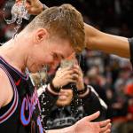 Chicago Bulls guard Kevin Huerter gets doused with water after an NBA basketball game against the Boston Celtics, Saturday, Jan. 24, 2026, in Chicago. Huerter scored the game winning three-point basket. (AP Photo/Matt Marton)