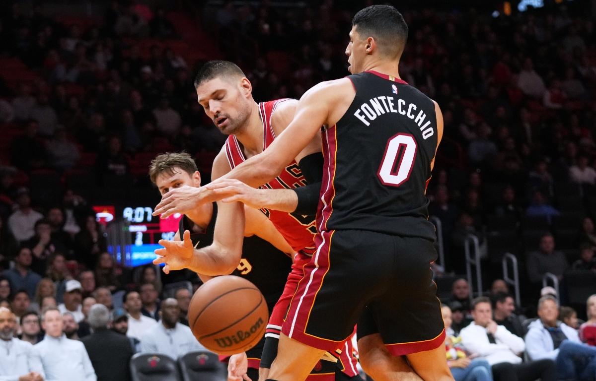 Chicago Bulls center Nikola Vucevic, center loses control of the ball as Miami Heat forward Simone Fontecchio (0) defends during the second half of an NBA basketball game, Sunday, Feb. 1, 2026, in Miami. (AP Photo/Lynne Sladky)