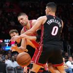 Chicago Bulls center Nikola Vucevic, center loses control of the ball as Miami Heat forward Simone Fontecchio (0) defends during the second half of an NBA basketball game, Sunday, Feb. 1, 2026, in Miami. (AP Photo/Lynne Sladky)
