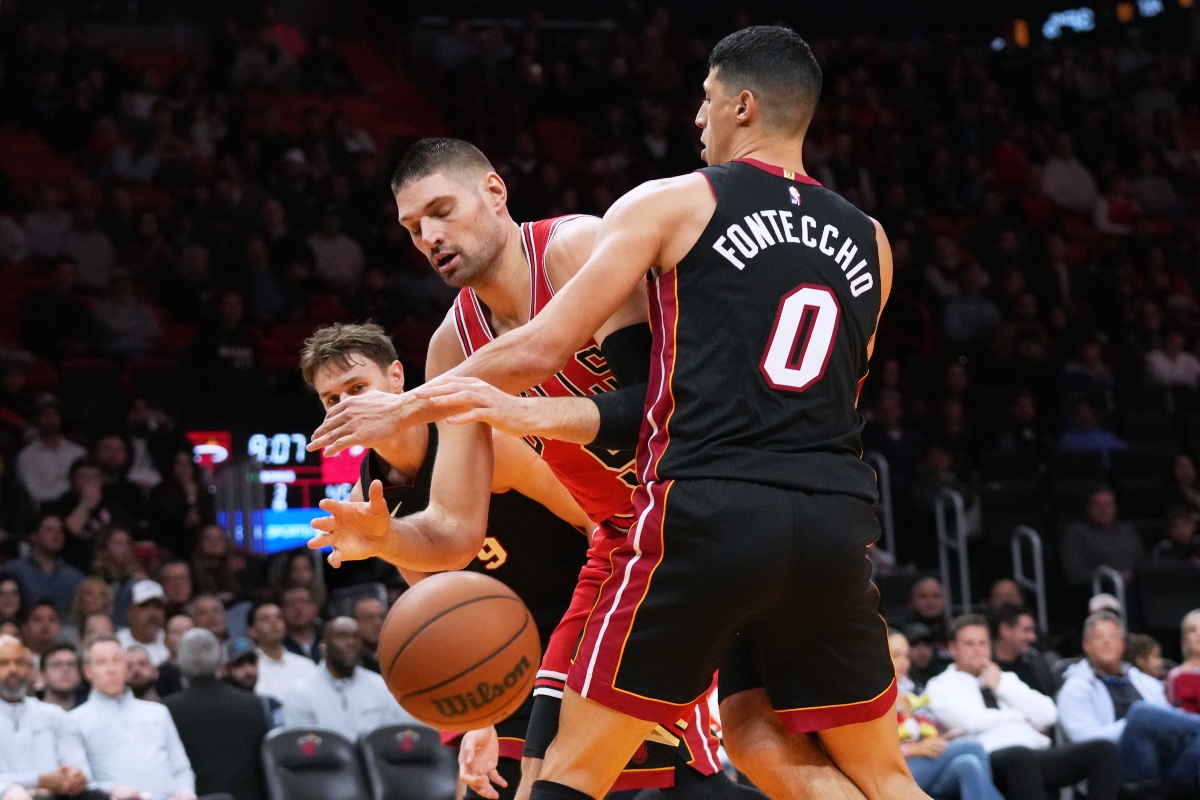 Chicago Bulls center Nikola Vucevic, center loses control of the ball as Miami Heat forward Simone Fontecchio (0) defends during the second half of an NBA basketball game, Sunday, Feb. 1, 2026, in Miami. (AP Photo/Lynne Sladky)
