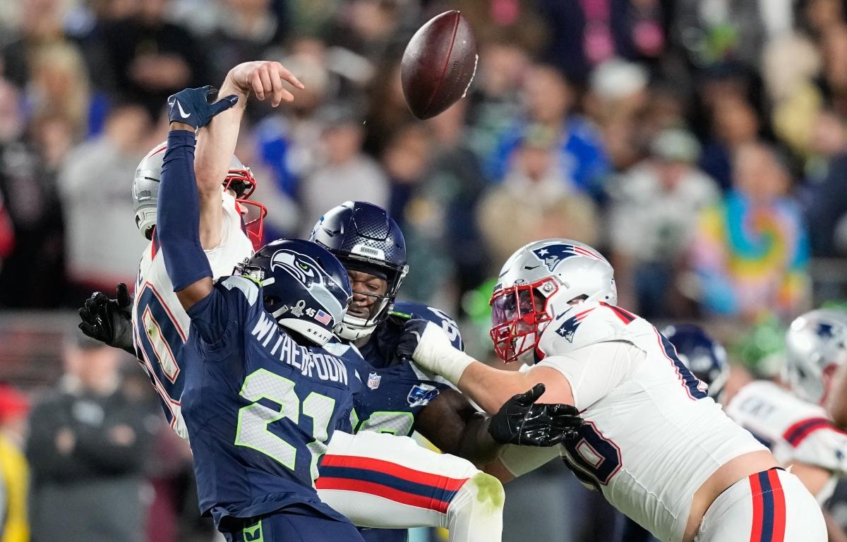 New England Patriots quarterback Drake Maye fumbles as he is hit by Seattle Seahawks cornerback Devon Witherspoon (21) during the second half of the NFL Super Bowl 60 football game, Sunday, Feb. 8, 2026, in Santa Clara, Calif. (AP Photo/Julio Cortez)