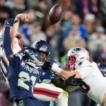 New England Patriots quarterback Drake Maye fumbles as he is hit by Seattle Seahawks cornerback Devon Witherspoon (21) during the second half of the NFL Super Bowl 60 football game, Sunday, Feb. 8, 2026, in Santa Clara, Calif. (AP Photo/Julio Cortez)
