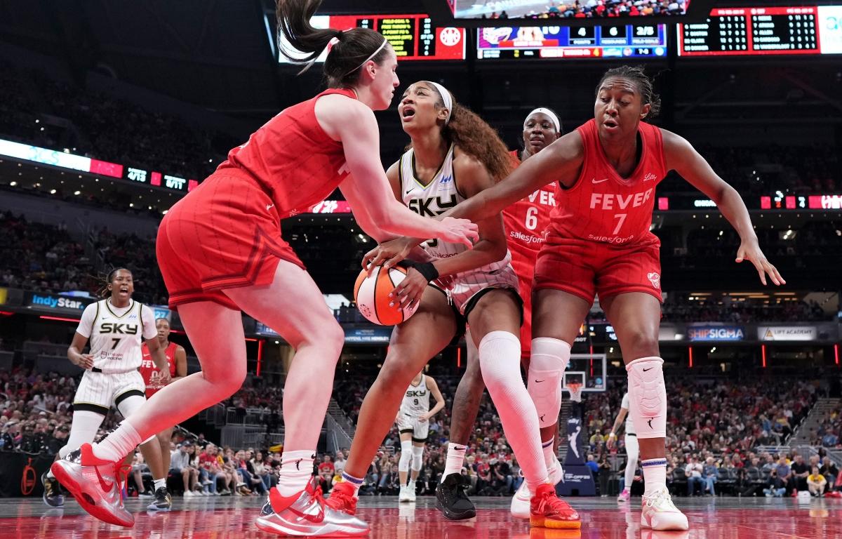 FILE - Indiana Fever guard Caitlin Clark, left, fouls Chicago Sky forward Angel Reese, center, during the second half an WNBA basketball game in Indianapolis, Saturday, May 17, 2025. (AP Photo/AJ Mast, File)