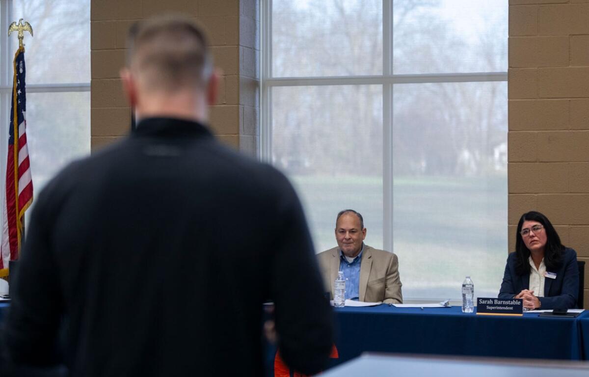 A father with children in the Carterville school district addresses officials during a board of education meeting about why they had not acted sooner to place an assistant football coach, accused of sexual abuse, on leave. (Photo by Lylee Gibbs, Saluki Local Reporting Lab)