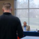 A father with children in the Carterville school district addresses officials during a board of education meeting about why they had not acted sooner to place an assistant football coach, accused of sexual abuse, on leave. (Photo by Lylee Gibbs, Saluki Local Reporting Lab)
