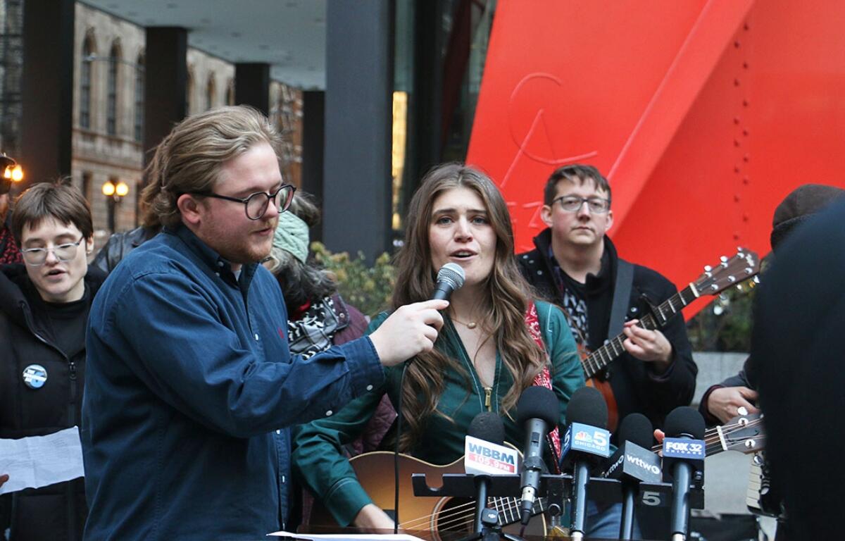 Joselyn Walsh, one of six people charge by federal prosecutors in connection to a September 2025 protest in Broadview, sings outside the Dirksen Federal Courthouse in Chicago in November. Conspiracy charges against her and another defendant were officially dropped on Friday, March 13. (Capitol News Illinois photo by Maggie Dougherty)