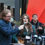 Joselyn Walsh, one of six people charge by federal prosecutors in connection to a September 2025 protest in Broadview, sings outside the Dirksen Federal Courthouse in Chicago in November. Conspiracy charges against her and another defendant were officially dropped on Friday, March 13. (Capitol News Illinois photo by Maggie Dougherty)
