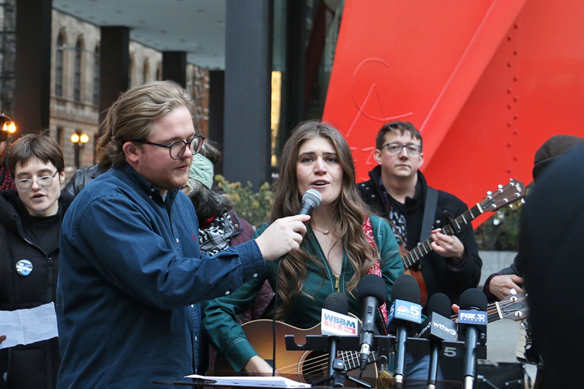 Joselyn Walsh, one of six people charge by federal prosecutors in connection to a September 2025 protest in Broadview, sings outside the Dirksen Federal Courthouse in Chicago in November. Conspiracy charges against her and another defendant were officially dropped on Friday, March 13. (Capitol News Illinois photo by Maggie Dougherty)
