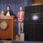 Kavi Chintham of Voter Solar gestures at a 391-watt plug-in solar panel and battery at a Thursday news conference about a bill to expand access to plug-in solar panel systems. (Capitol News Illinois photo by Nikoel Hytrek)