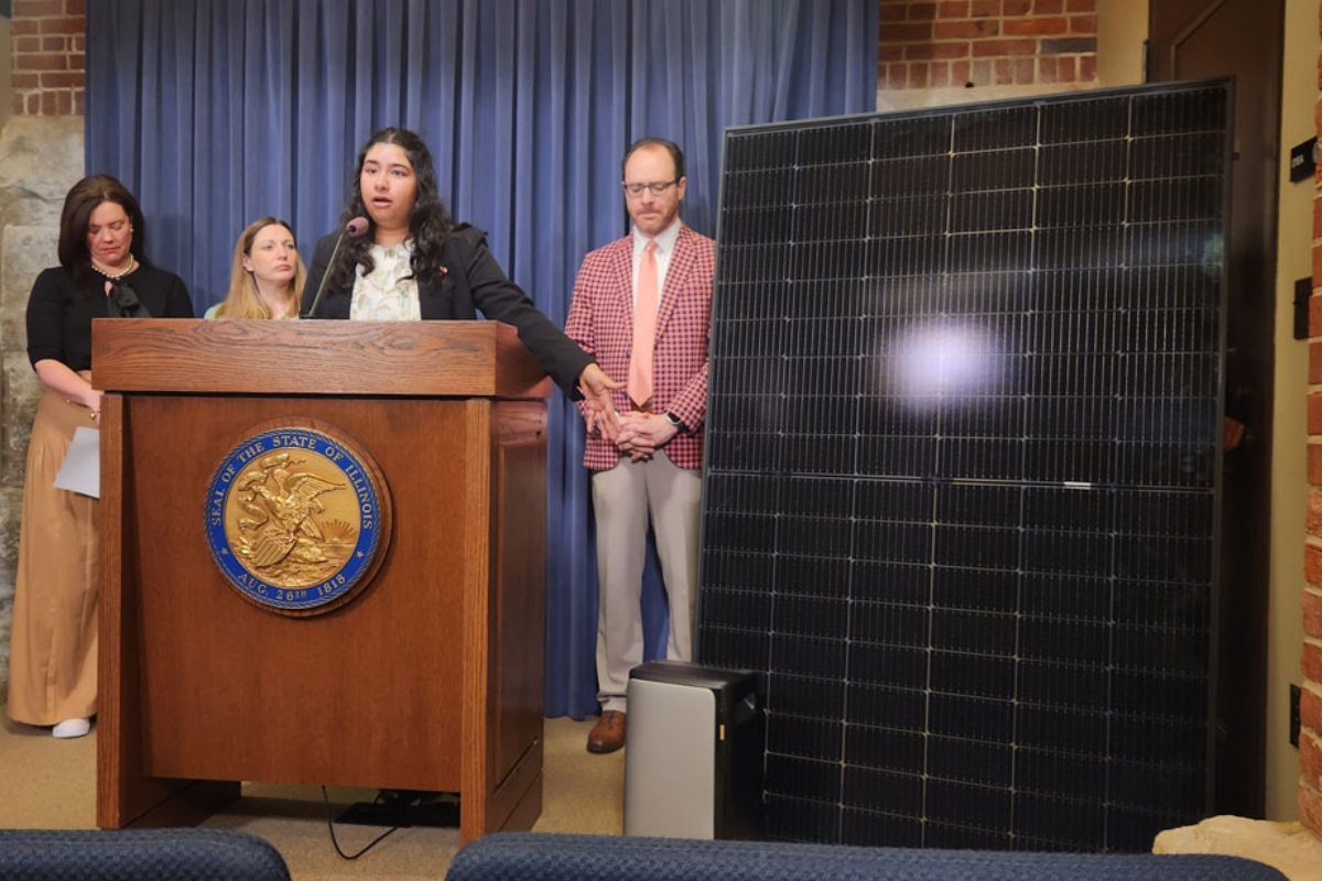 Kavi Chintham of Voter Solar gestures at a 391-watt plug-in solar panel and battery at a Thursday news conference about a bill to expand access to plug-in solar panel systems. (Capitol News Illinois photo by Nikoel Hytrek)