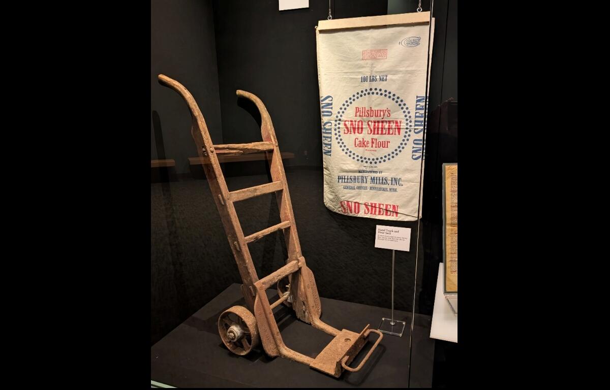 A handcart and flour sack used at the former Pillsbury plant are now part of a display at the Abraham Lincoln Presidential Library and Museum.