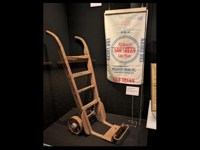 A handcart and flour sack used at the former Pillsbury plant are now part of a display at the Abraham Lincoln Presidential Library and Museum.