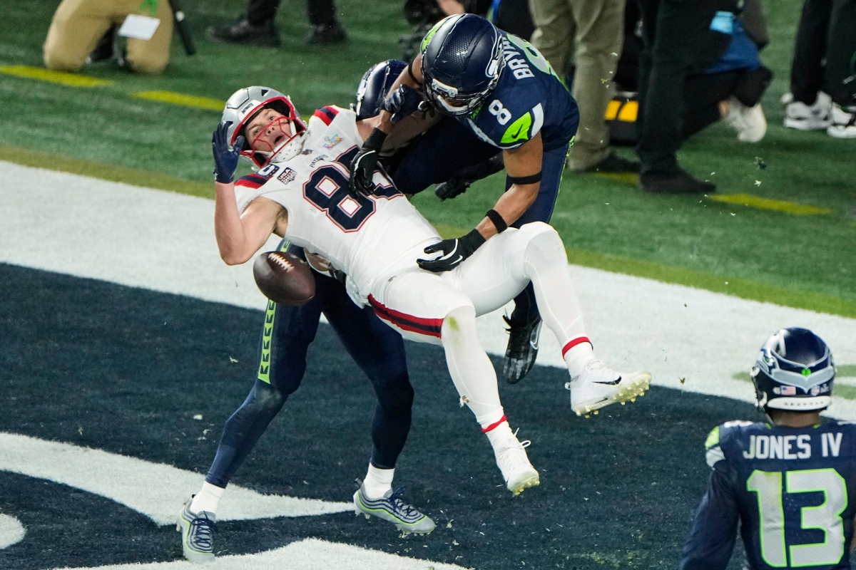 New England Patriots tight end Hunter Henry (85) is unable to catch a two-point conversion as Seattle Seahawks' Coby Bryant (8) and Josh Jobe, rear, defend during the second half of the NFL Super Bowl 60 football game, Sunday, Feb. 8, 2026, in Santa Clara, Calif. (AP Photo/Charlie Riedel)