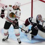 Chicago Blackhawks left wing Nick Foligno, left, redircts a shot into the glove of Colorado Avalanche goaltender MacKenzie Blackwood in the third period of an NHL hockey game Saturday, Feb. 28, 2026, in Denver. (AP Photo/David Zalubowski)