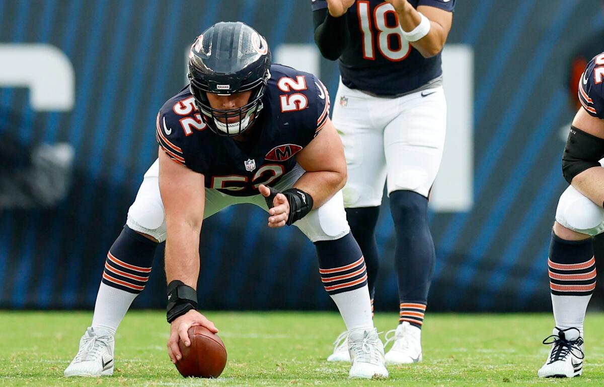 FILE - Chicago Bears center Drew Dalman (52) prepares to snap the ball during the second half of an NFL football game against the Dallas Cowboys, Sunday, Sept. 21, 2025, in Chicago. (AP Photo/Kamil Krzaczynski, File)