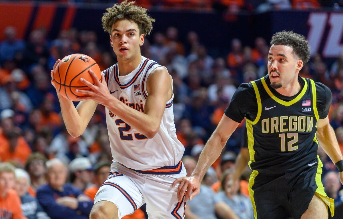 Illinois' Keaton Wagler advances the ball as Oregon's Drew Carter pursues during an NCAA college basketball game Tuesday, March 3, 2026, in Champaign, Ill. (AP Photo/Craig Pessman)