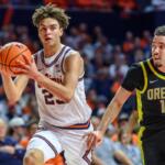 Illinois' Keaton Wagler advances the ball as Oregon's Drew Carter pursues during an NCAA college basketball game Tuesday, March 3, 2026, in Champaign, Ill. (AP Photo/Craig Pessman)