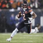 FILE - Chicago Bears wide receiver DJ Moore runs after making a catch against the Los Angeles Rams during the first half of an NFL football divisional playoff game, Jan. 18, 2026, in Chicago. (AP Photo/Jeff Roberson, File)