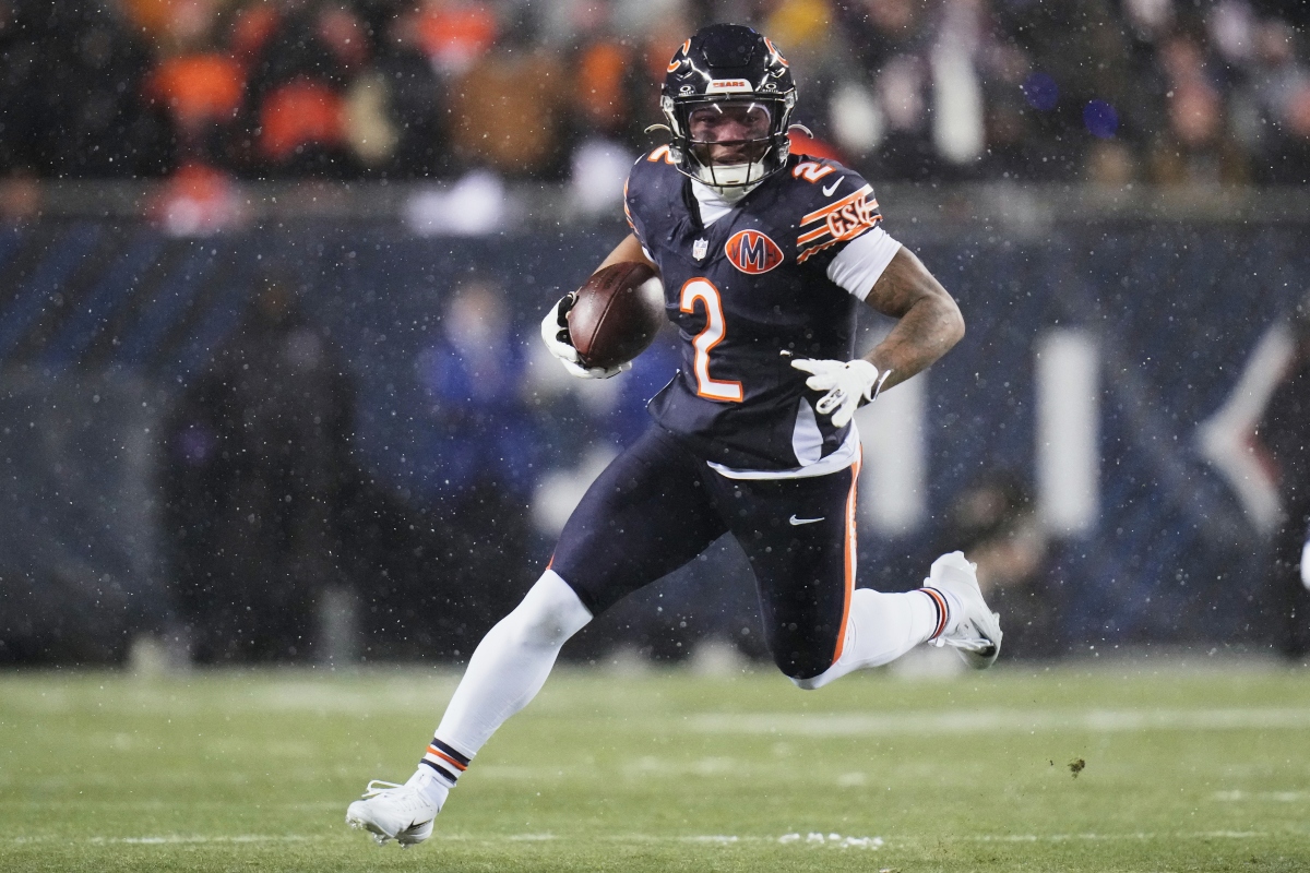 FILE - Chicago Bears wide receiver DJ Moore runs after making a catch against the Los Angeles Rams during the first half of an NFL football divisional playoff game, Jan. 18, 2026, in Chicago. (AP Photo/Jeff Roberson, File)