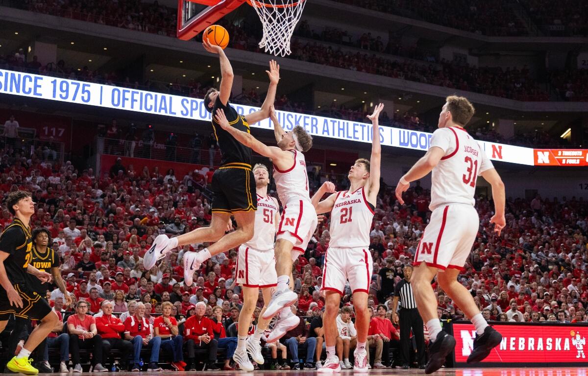 From left, Iowa's Alvaro Folgueiras shoots against Nebraska's Rienk Mast, Sam Hoiberg, Pryce Sandfort and Cale Jacobsen during the second half of an NCAA college basketball game Sunday, March 8, 2026, in Lincoln, Neb. (AP Photo/Rebecca S. Gratz)
