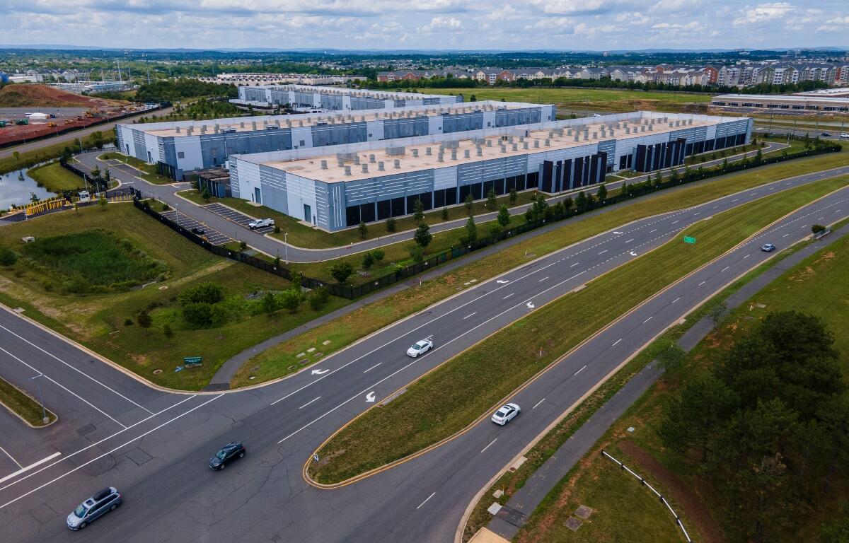 FILE - Cars drive past data centers that house computer servers and hardware required to support modern internet use, such as artificial intelligence, in Ashburn, Virginia, July 16, 2023. (AP Photo/Ted Shaffrey, File)