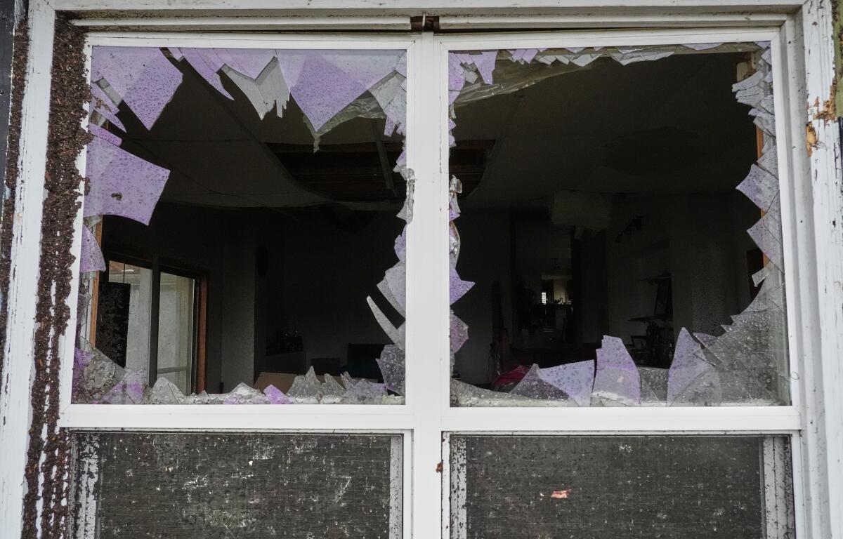 A window is damaged in the aftermath of a powerful storm that ripped through the area a day earlier in Kankakee, Ill., Wednesday, March 11, 2026. (AP Photo/Nam Y. Huh)