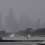 A person bundles up and fishes on a breakwater by Montrose Harbor, Monday morning, March 16, 2026, in downtown Chicago. (AP Photo/Kiichiro Sato)