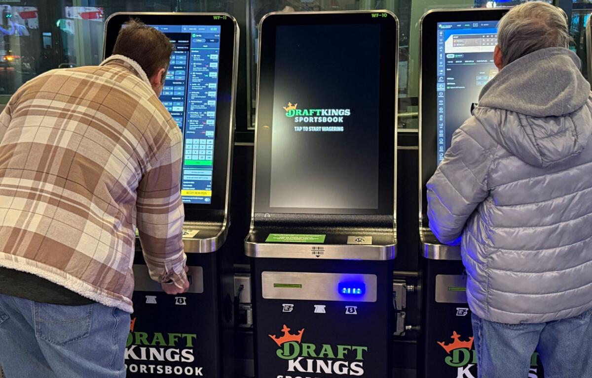 Bettors gather at the DraftKings betting kiosks at Chicago’s Wrigley Field. Despite having one of the most aggressive tax structures, Illinois still ranks third in the U.S. in sports betting revenue (Medill Illinois News Bureau photo by Erika Tulfo)