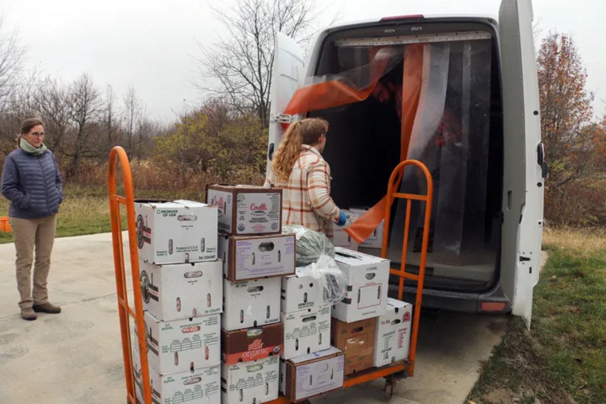 Traci Barkley, director of Sola Gratia Farm, watches as staff load produce into the farm’s refrigerated delivery van, which was purchased with the support of funding from the Illinois’ Local Food Infrastructure Grant program. (Capitol News Illinois photo by Maggie Dougherty)