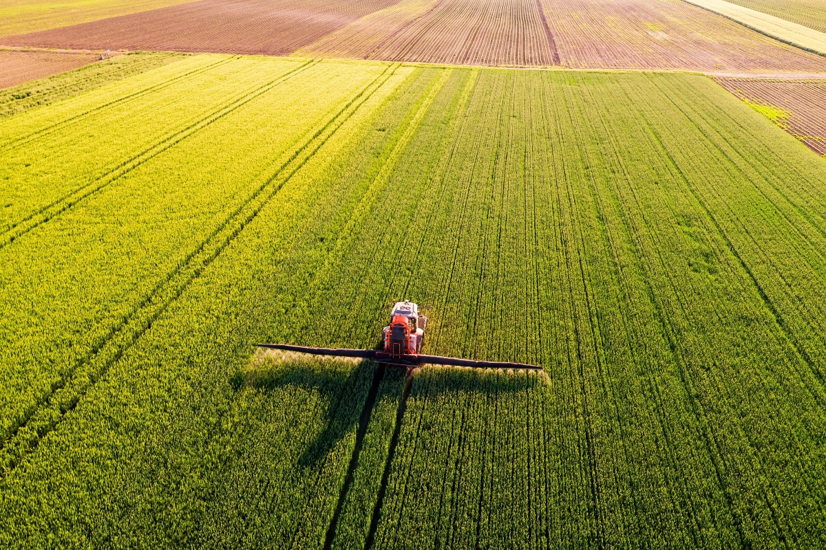 A farmer applies fertilizer to his field.