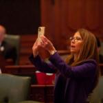 Rep. Jennifer Gong-Gershowitz, D-Glenview, takes a picture of the vote board in the Illinois House after the passage of a bill in May 2023. (Capitol News Illinois photo by Jerry Nowicki)