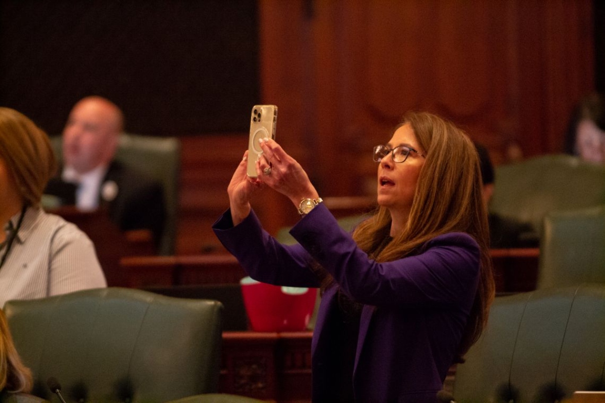 Rep. Jennifer Gong-Gershowitz, D-Glenview, takes a picture of the vote board in the Illinois House after the passage of a bill in May 2023. (Capitol News Illinois photo by Jerry Nowicki)