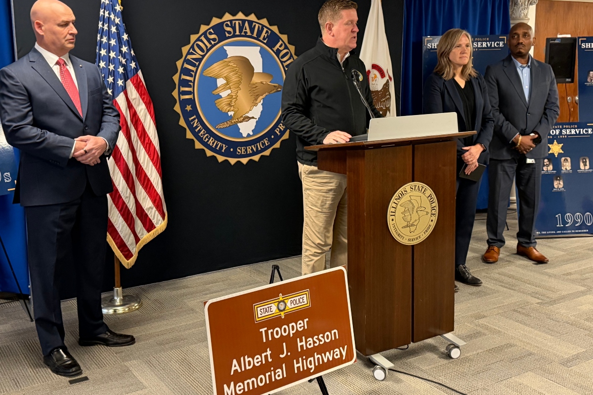 Brendan Kelly (center), Director of Illinois State Police, announces the installation of highway signs for all 73 troopers who have died in the line of duty. Trooper Albert Hassan is the first trooper, who died in 1924.