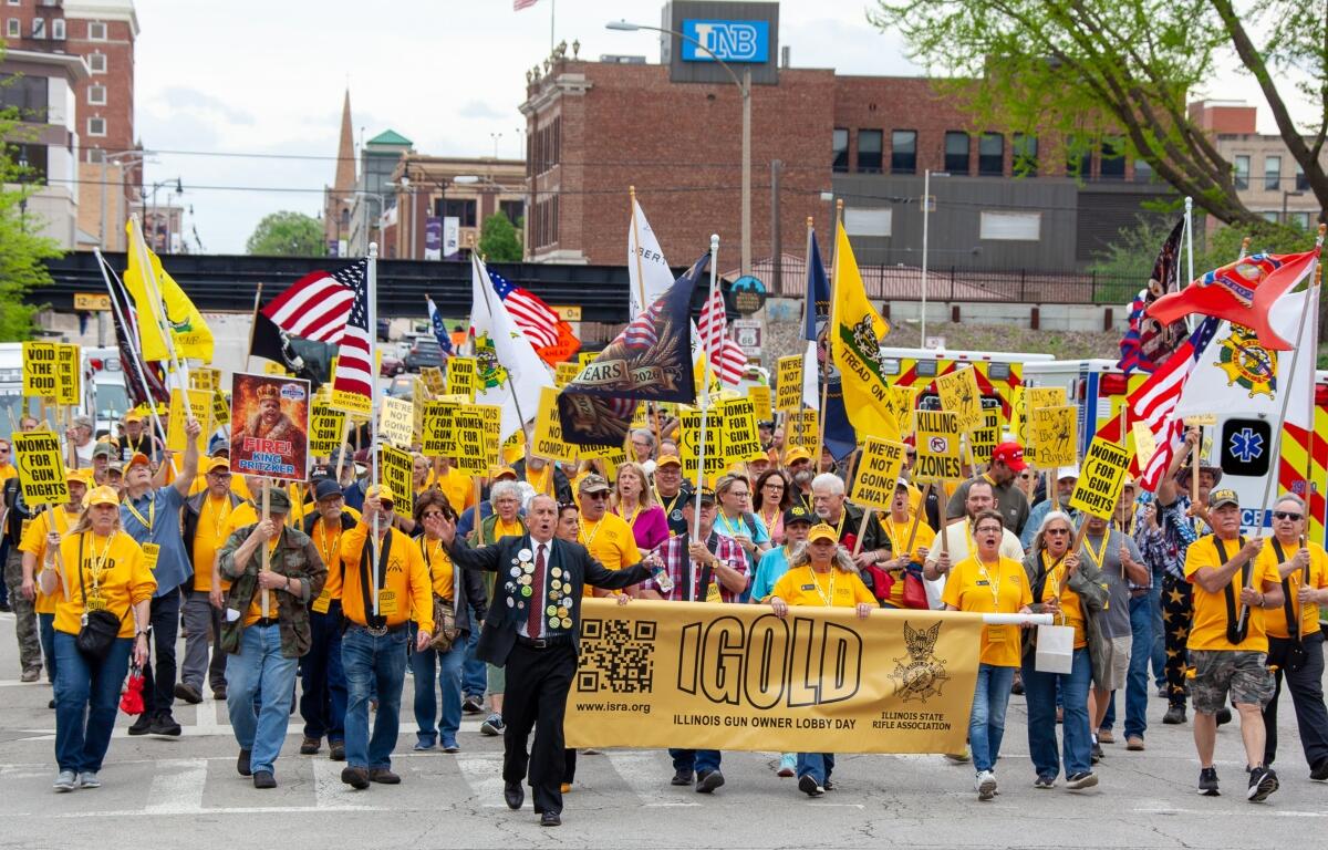 Participants in the annual Illinois Gun Owners Lobbying Day (IGOLD) march from the Bank of Springfield Center to the Illinois Capitol Wednesday, April 15.