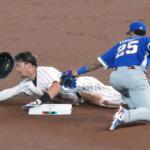 Japan's Seiya Suzuki is tagged out at second base by Venezuela's Gleyber Torres during the first inning of a World Baseball Classic quarterfinal game against Japan, Saturday, March 14, 2026, in Miami. (AP Photo/Marta Lavandier)