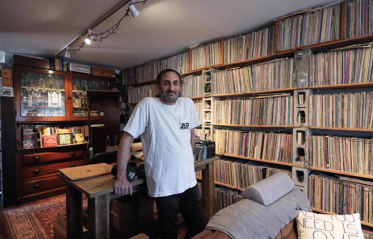 Aadam Jacobs poses in front of LP (long play) record storage bookcase at his home in Chicago, Thursday, March 19, 2026. (AP Photo/Nam Y. Huh)