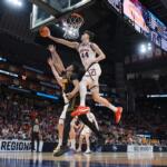 Iowa's Tavion Banks (6) has his shot blocked by Illinois' Zvonimir Ivisic (44) during the first half of an Elite Eight game in the NCAA college basketball tournament Saturday, March 28, 2026, in Houston. (AP Photo/Eric Gay)
