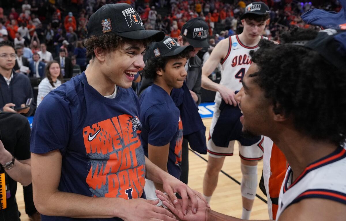 Illinois' Keaton Wagler, left, celebrates with a teammate after Illinois beat Iowa in an Elite Eight game in the NCAA college basketball tournament Saturday, March 28, 2026, in Houston. (AP Photo/Eric Gay)