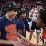 Illinois' Keaton Wagler, left, celebrates with a teammate after Illinois beat Iowa in an Elite Eight game in the NCAA college basketball tournament Saturday, March 28, 2026, in Houston. (AP Photo/Eric Gay)