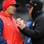 Los Angeles Angels manager Kurt Suzuki, left, attempts to challenge a play with an umpire during the third inning of a baseball game against the Chicago Cubs in Chicago, Wednesday, April 1, 2026. (AP Photo/Paul Beaty)