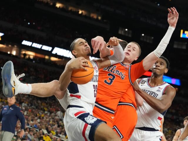 UConn's Jayden Ross (23) and Illinois' Ben Humrichous (3) battle for the ball during the first half of an NCAA college basketball tournament semifinal game at the Final Four, Saturday, April 4, 2026, in Indianapolis. (AP Photo/Michael Conroy)