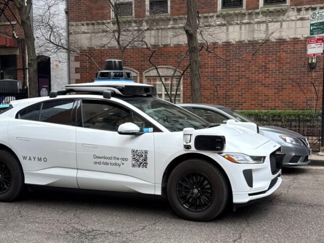 A Waymo vehicle drives through Chicago’s Near North Side on March 20 as the company begins testing and mapping the city. (Medill Illinois News Bureau photo by Georgia Epiphaniou)