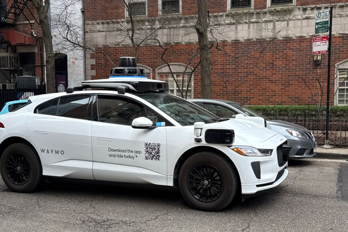 A Waymo vehicle drives through Chicago’s Near North Side on March 20 as the company begins testing and mapping the city. (Medill Illinois News Bureau photo by Georgia Epiphaniou)